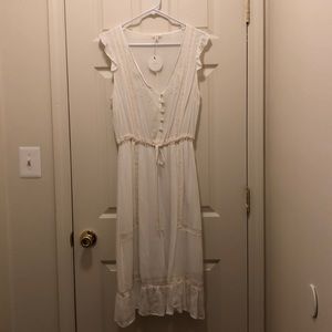 Beautifully embroidered, sleeveless cream, dress.